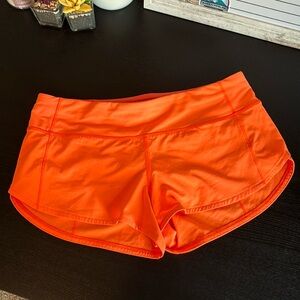 Lululemon Speed Up 2.5” Highlight Orange low rise shorts; size 6